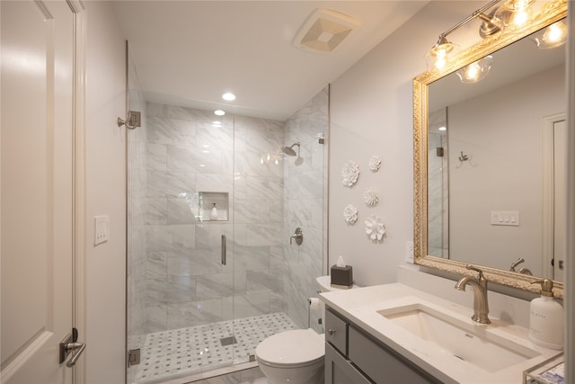 bathroom with vanity, toilet, and an enclosed shower