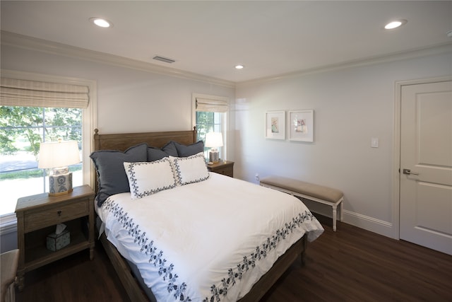 bedroom with crown molding and dark wood-type flooring