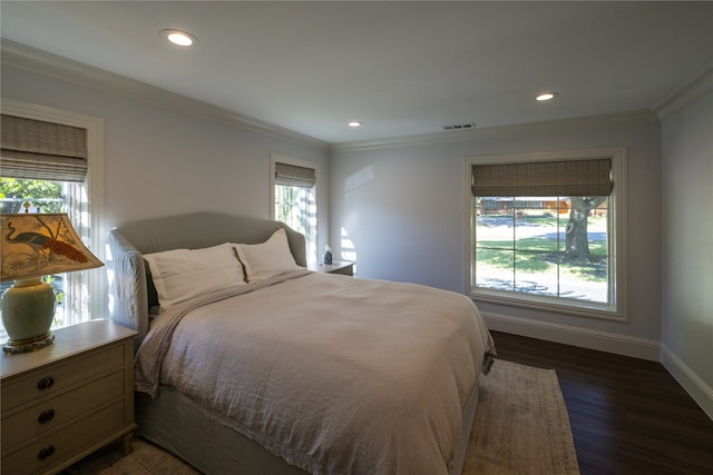 bedroom featuring crown molding and dark wood-type flooring