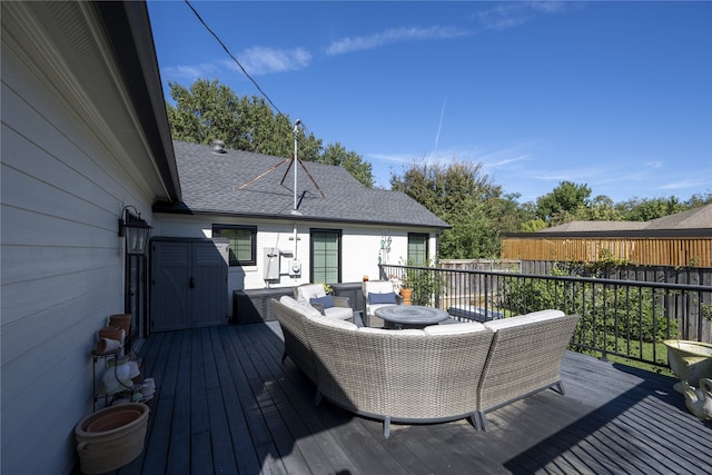 deck with an outdoor living space and a storage unit