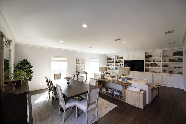 dining room with crown molding and dark wood-type flooring