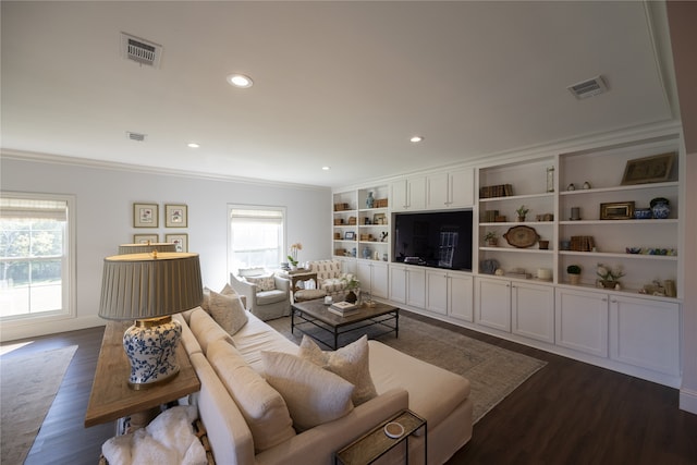 living room featuring a healthy amount of sunlight, ornamental molding, and dark wood-type flooring