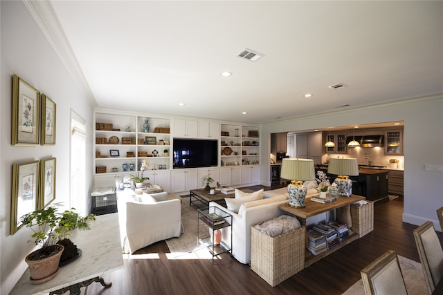 living room with built in features, ornamental molding, and hardwood / wood-style flooring