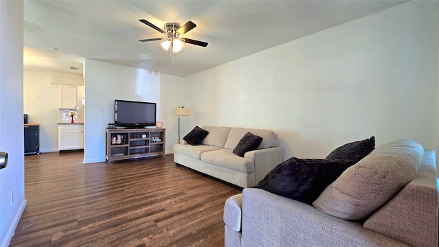 living room with dark hardwood / wood-style flooring, ceiling fan, and lofted ceiling