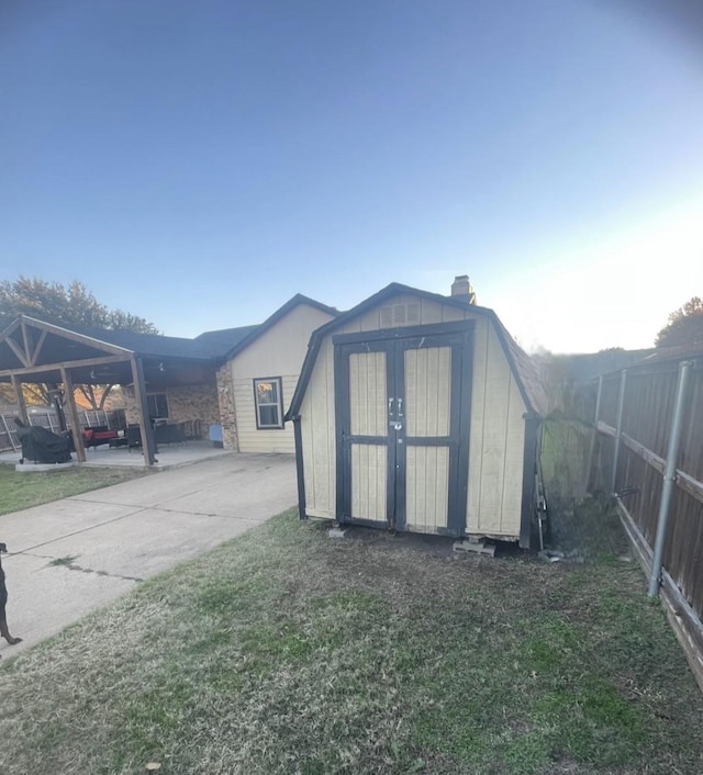 view of outbuilding with a lawn