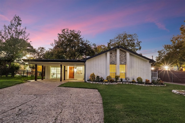 ranch-style home with a yard