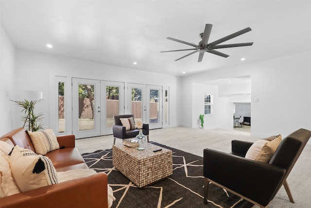 living room featuring carpet flooring, ceiling fan, and french doors