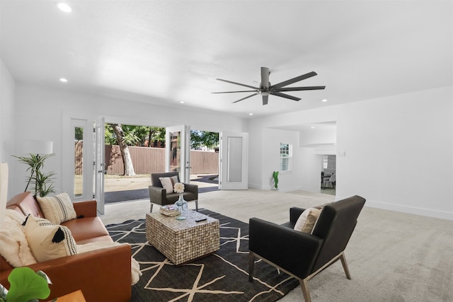 living room with ceiling fan and light colored carpet