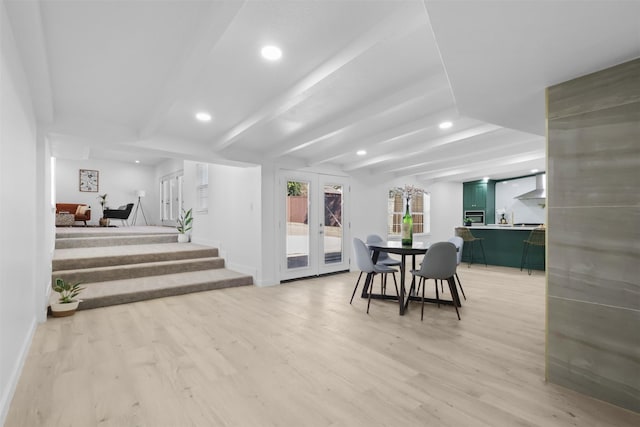 dining space featuring wood-type flooring and beam ceiling