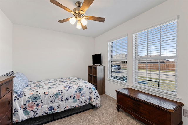 bedroom with ceiling fan and light colored carpet