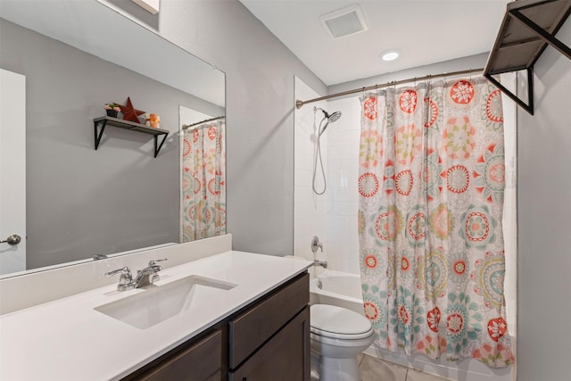 full bathroom with tile patterned flooring, shower / bath combination with curtain, vanity, and toilet