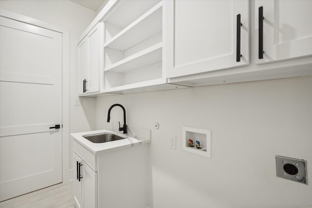 laundry room with sink, washer hookup, cabinets, hookup for an electric dryer, and light hardwood / wood-style flooring