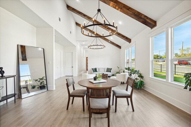 dining room featuring a chandelier, beam ceiling, high vaulted ceiling, and light hardwood / wood-style flooring