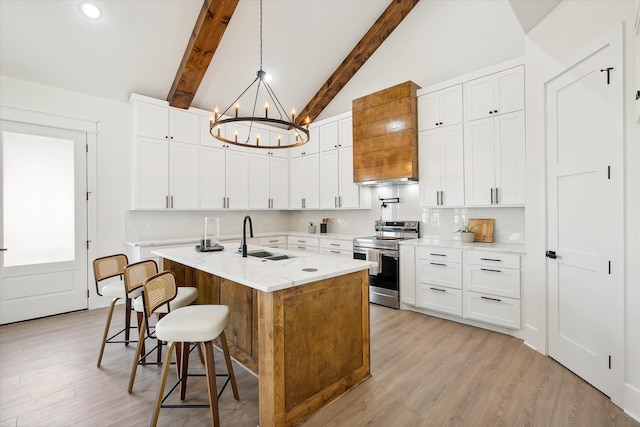 kitchen with white cabinetry, stainless steel electric range oven, sink, and an island with sink