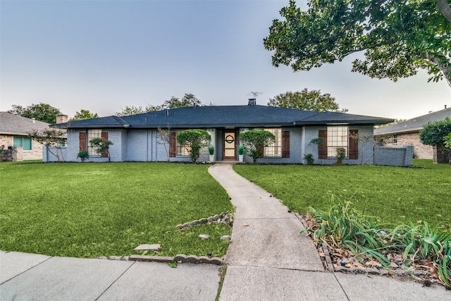 ranch-style home with a front lawn