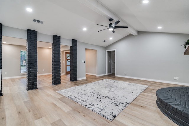 living area featuring light wood-type flooring, lofted ceiling with beams, decorative columns, and ceiling fan