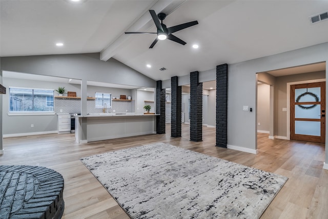 interior space featuring vaulted ceiling with beams, light hardwood / wood-style flooring, and ceiling fan