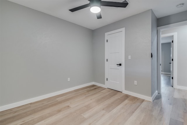 unfurnished bedroom with ceiling fan and light wood-type flooring