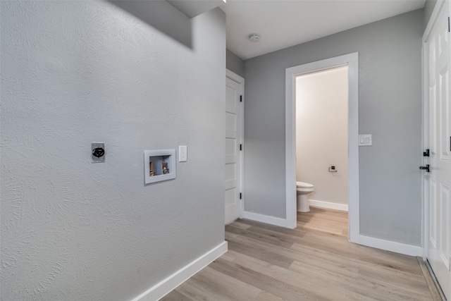 washroom with washer hookup, electric dryer hookup, and light hardwood / wood-style flooring