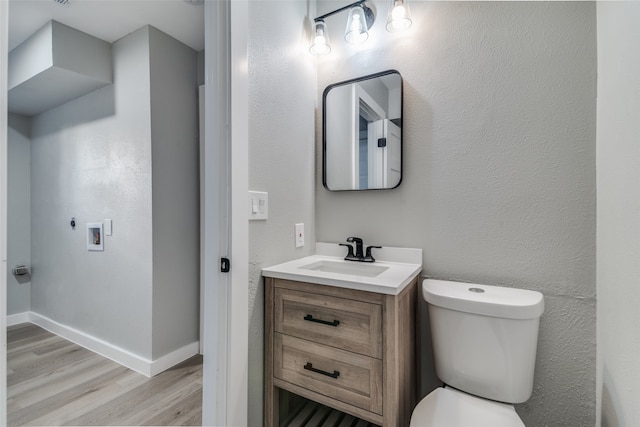 bathroom featuring vanity, toilet, and wood-type flooring