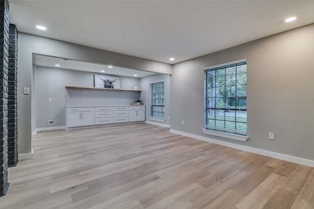 unfurnished living room with light hardwood / wood-style flooring