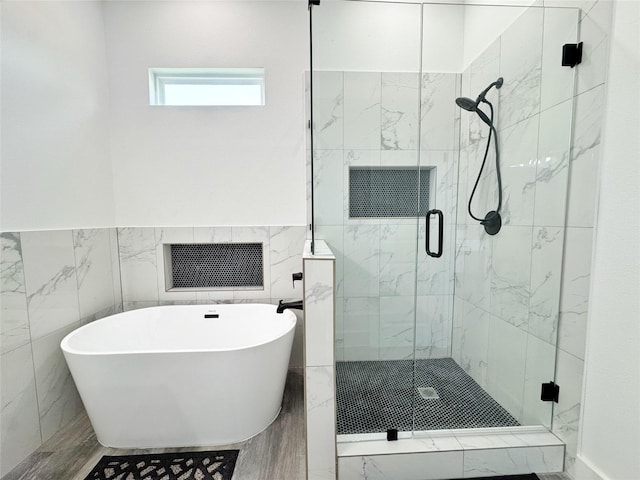 3210 Houston St, Greenville, TX 75401 - bathroom featuring tile walls, visible vents, a freestanding bath, and a stall shower