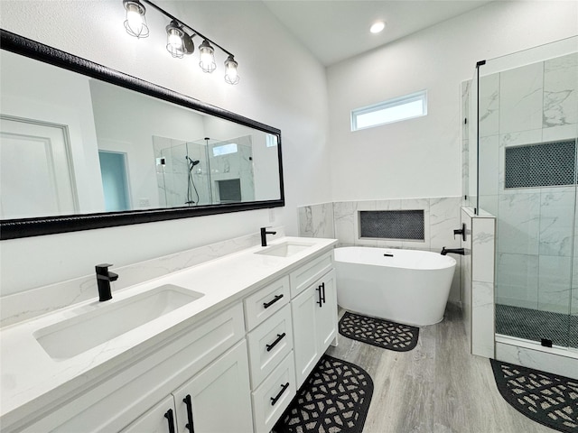 3210 Houston St, Greenville, TX 75401 - bathroom with wood finished floors, a sink, double vanity, and a stall shower