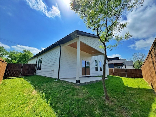 3210 Houston St, Greenville, TX 75401 - back of house featuring a lawn, a fenced backyard, and a patio