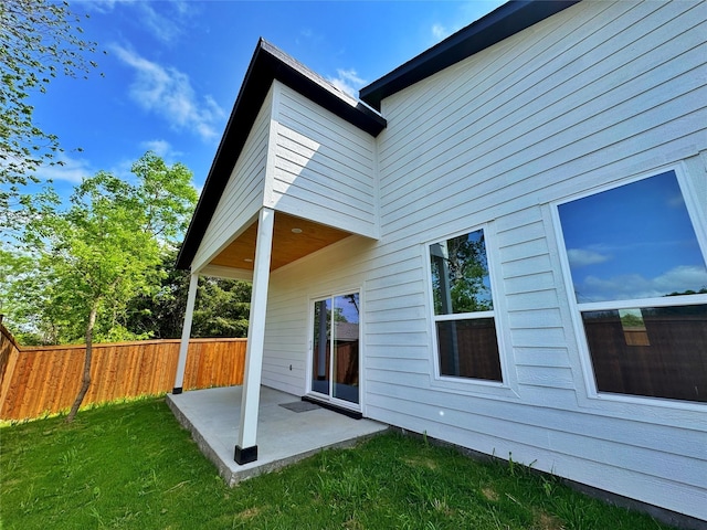 3210 Houston St, Greenville, TX 75401 - rear view of property featuring fence, a yard, and a patio