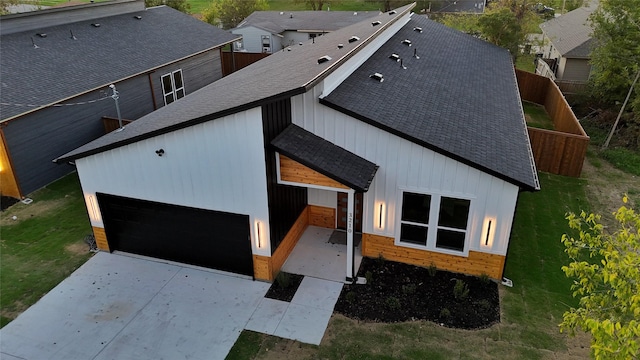 3210 Houston St, Greenville, TX 75401 - view of front facade with concrete driveway, a front lawn, roof with shingles, and fence