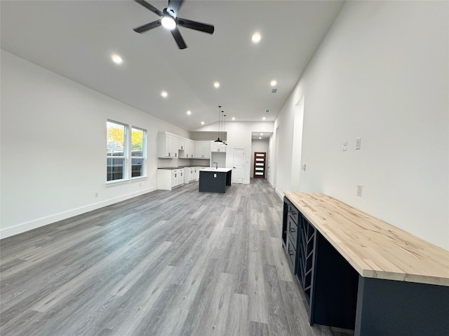 unfurnished living room featuring ceiling fan and wood-type flooring