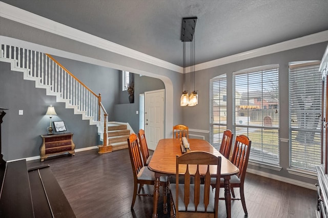 dining area with ornamental molding, dark hardwood / wood-style floors, and a textured ceiling