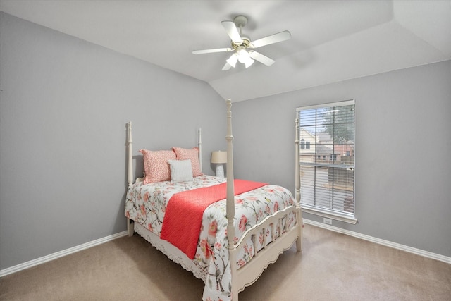 bedroom with ceiling fan, lofted ceiling, and carpet flooring