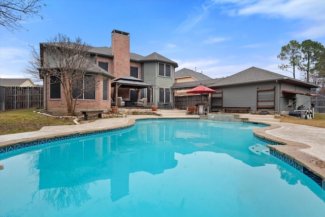 view of swimming pool featuring a gazebo and a patio area