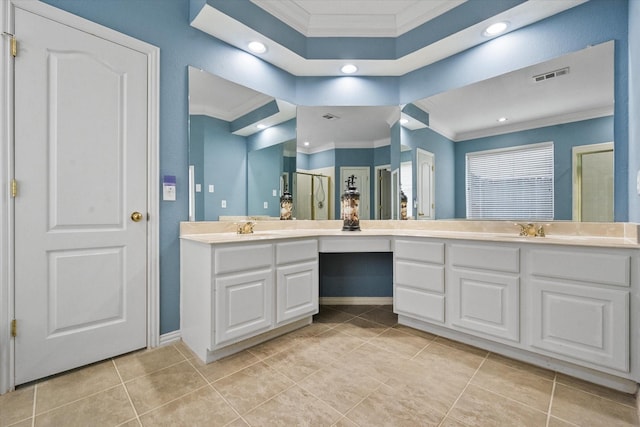 bathroom featuring vanity, crown molding, a shower with door, and tile patterned floors