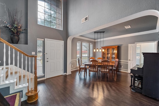 entryway featuring ornamental molding and dark wood-type flooring