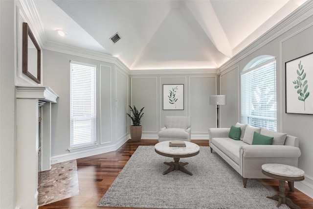 living room featuring dark wood-type flooring, vaulted ceiling, and ornamental molding