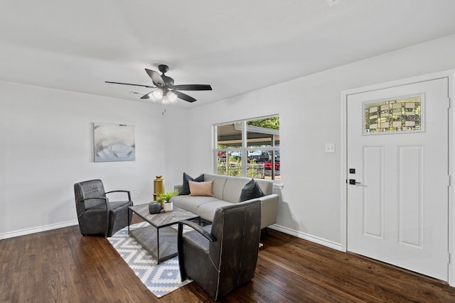 living room featuring ceiling fan and dark hardwood / wood-style floors