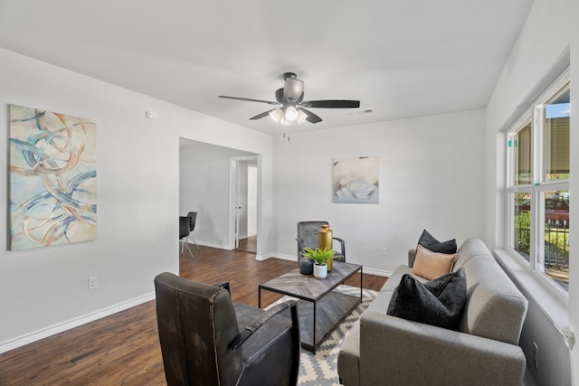 living room featuring ceiling fan and dark hardwood / wood-style floors