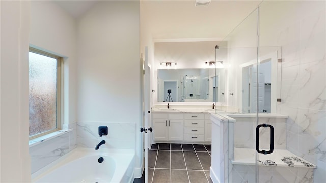 bathroom featuring tile patterned floors, vanity, plus walk in shower, and a wealth of natural light