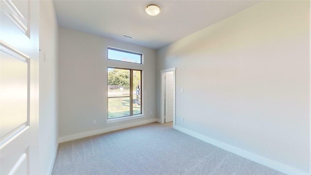 unfurnished room featuring light colored carpet