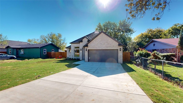 view of front of property with a front yard and a garage