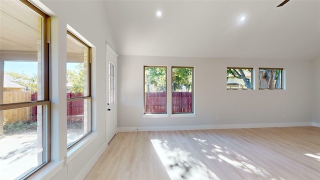 spare room featuring light hardwood / wood-style flooring and a healthy amount of sunlight