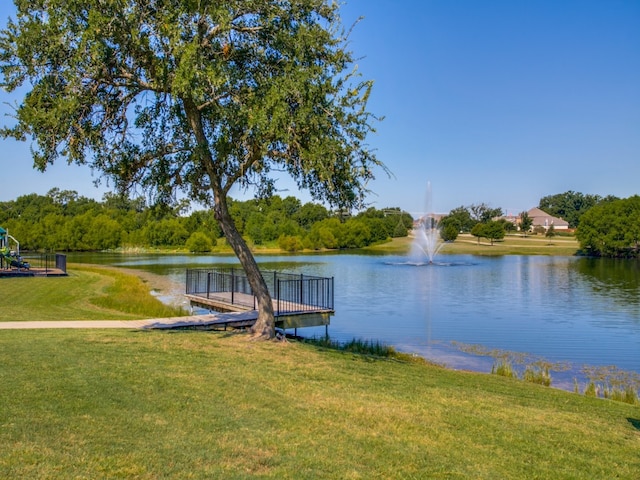 view of dock featuring a water view and a lawn