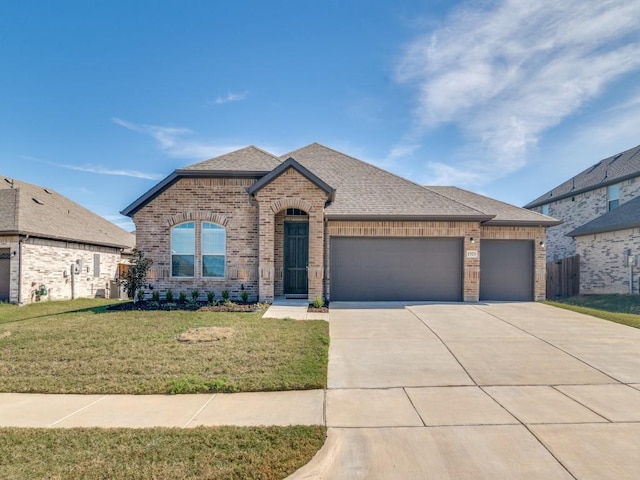 1523 Green Meadows Way, Wylie, TX 75098 - french country inspired facade with brick siding, a garage, driveway, a front yard, and a shingled roof