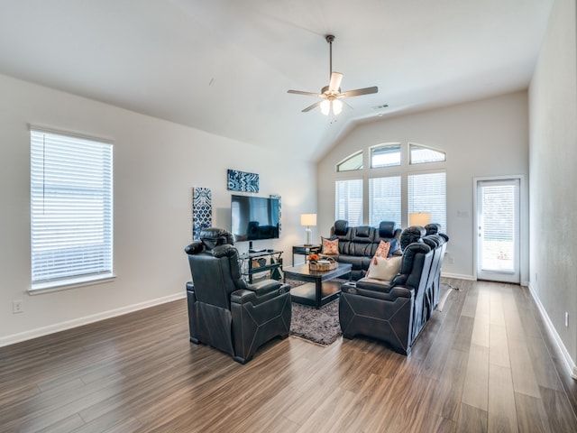 living room with ceiling fan, lofted ceiling, and hardwood / wood-style floors