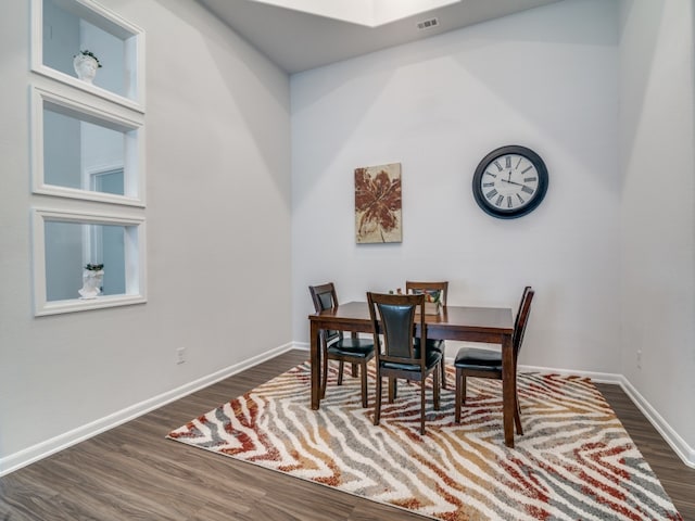 dining room with dark wood-type flooring