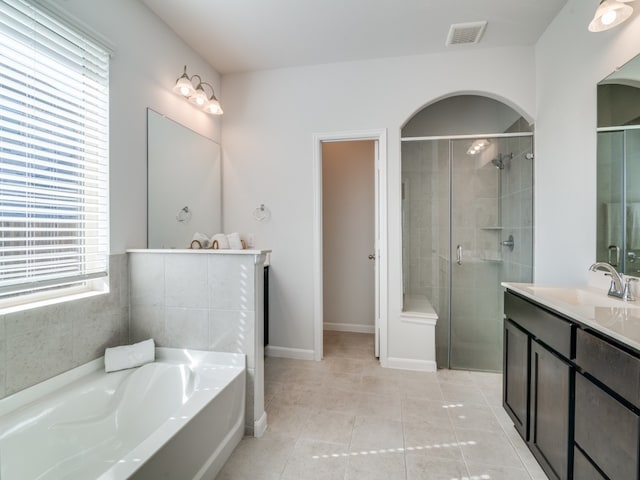 bathroom featuring vanity, plus walk in shower, and tile patterned flooring