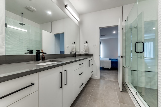 bathroom with tile patterned floors, vanity, and walk in shower