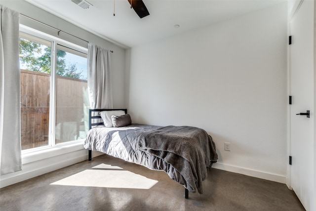 bedroom featuring ceiling fan and concrete floors